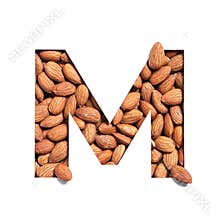 Letter M of English alphabet made of almonds and paper cut isolated on white. Typeface from nuts
