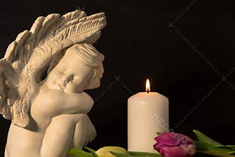 Statue of sad angel as symbol of pain, fear and end of life. Remembrance concept