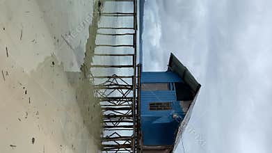 Pier Against Turquoise Sea In Kaimana Island. Vertical Video Of Wooden Bungalow On Peaceful And Tranquil Pacific Lagoon Water