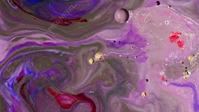 Close-up oil paints in vibrant purples are mixed together like artwork