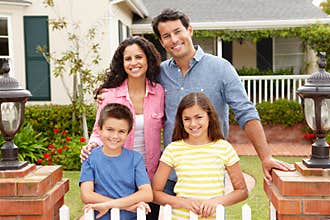 Hispanic family standing outside home