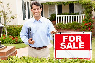 Real estate agent standing outside house