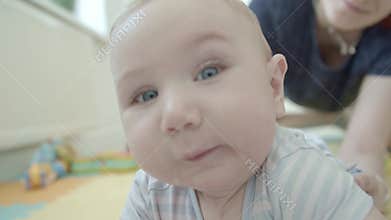 A little baby wanting to play with the camera