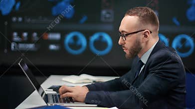 Male financial trader working use laptop at global stock exchange. Shot with RED camera in 4K