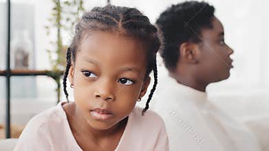 Portrait of little african american girl sad daughter feels disappointment after quarrel with afro mother older sister