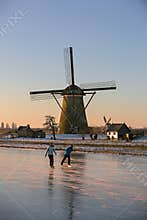 Ice skater in front of the Kinderdijk windmills