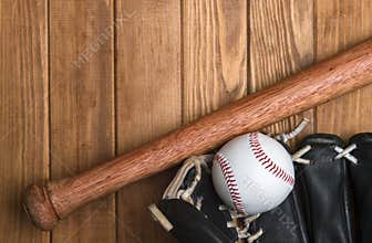 Baseball bat, glove and ball on wooden floor.  Sport theme background with copy space for text and advertisment