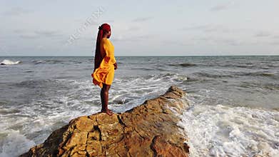 Africa woman walking on stone cliffs
