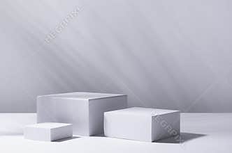 White square podiums in sunlight with shadow palm leaf in white space. Tropical showcase for cosmetic products, goods, shoes, bags