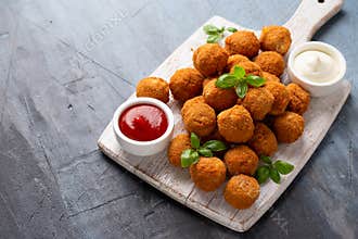 Meat free vegetarian mini picnic scotch eggs with micoprotein and herbs served with ketchup and mayonnaise