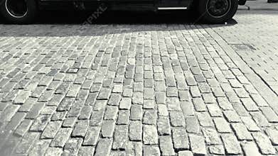 Cars and taxi cabs on cobblestone street