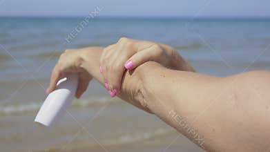 Woman applying sunscreen lotion