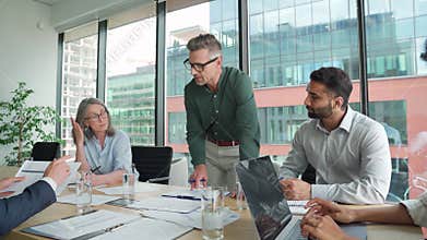 Executive team people listening ceo discussing paperwork at board meeting.
