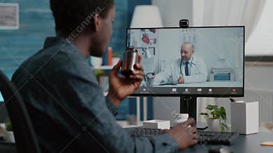 Black man at home seeking medical help from doctor