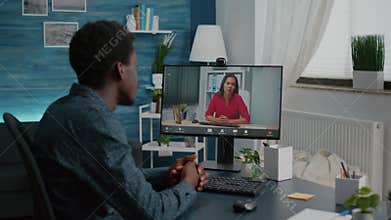 Zoom in shot on black man remote working talking with boss via online webcam