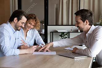 Happy couple of clients signing house buying, rent contract