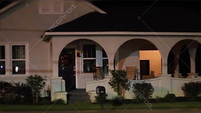 Creepy beautiful old white house at night in rural Georgia and cars passing