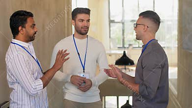 Businessmen with name tags talking at office