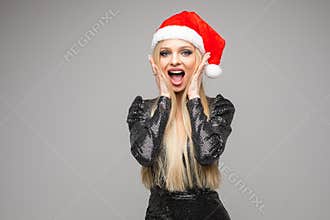 Happy Christmas lady wearing Santa hat and smiling