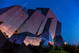 Futuroscope, glass buliding with sunset over Poitiers town mirrored in the glass walls