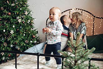 A cheerful family with one pretty small son have a lot of fun together