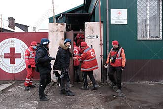 MARIUPOL, UKRAINE - 5 MARCH 2022: Unknown Red Cross war press works during bombardment by Russian aviation, artillery.