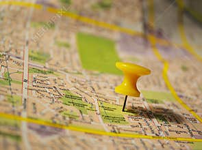 Yellow pushpin on a map