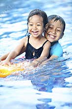 Sibling having fun at swimming pool