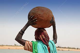 Woman carrying a pot