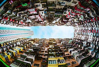 Fisheye lens view of tall vertical housing in Hong Kong