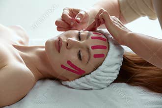 Face lift tape. Cosmetologist apply lifting tapes on female facial skin. Rejuvenation anti wrinkle procedure, no surgery