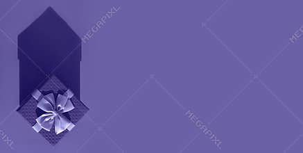 The color Is Very Peri. A gift box with a large bow and a shadow in the form of a house. A banner for the design of the ad.