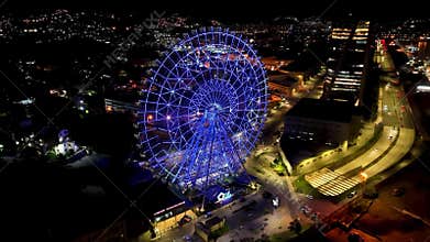 Night panoramic landscape of illuminated ferris wheel at Rio de Janeiro Brazil
