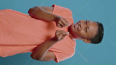 Playful woman doing money sign and asking for payment