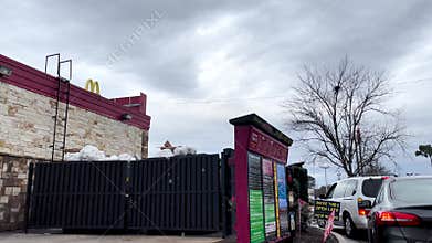 Cook Out fast food restaurant drive thru menu board cars and overflowing trash dumpsters