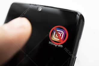 crossed-out icon on a black smartphone screen. the concept of banning the application instagram