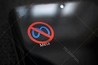 A crossed-out logo on a black smartphone screen. the concept of banning the application meta company. April 1, 2022. Barnaul.