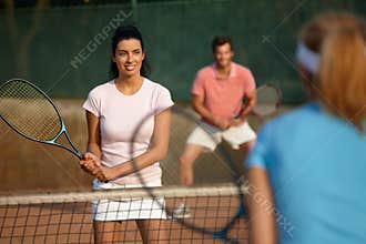 Young people playing mixed doubles