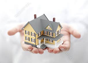 Yellow house in hands