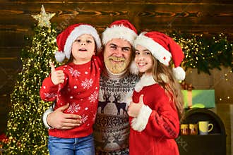By golly, be jolly. dad and daughters decorate home. bearded santa man with kids. christmas tree lights. perfect winter
