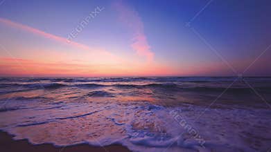 Sea sunrise. Rising sun and colorful sky clouds over ocean waves and beach