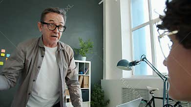 Mad employer yelling at female worker throwing paper bullying employee in office