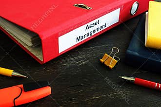 Asset Management folder with papers on the desk.