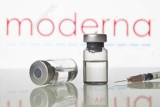 Vaccine vials and syringe with Moderna Inc logo