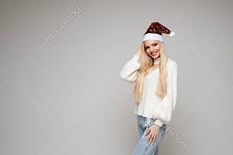 Beautiful young woman with blonde hair poses on camera, picture isolated on white backgroung