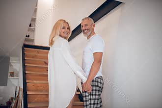 Man and woman standing on stairs and looking excited