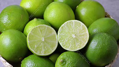 Basket with whole and halved fresh limes