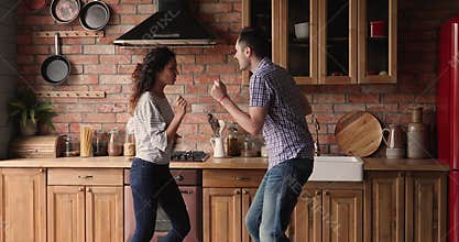Couple dancing in kitchen celebrate moving day to new home