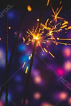 Vertical photography of atmospheric sparklers festive background with blurred bokeh