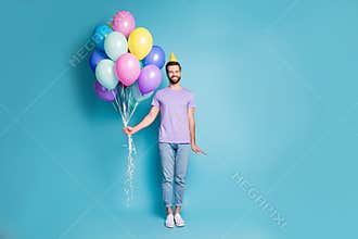 Full length body size photo of funny birthday man with balloons wearing yellow cone smiling isolated on bright blue